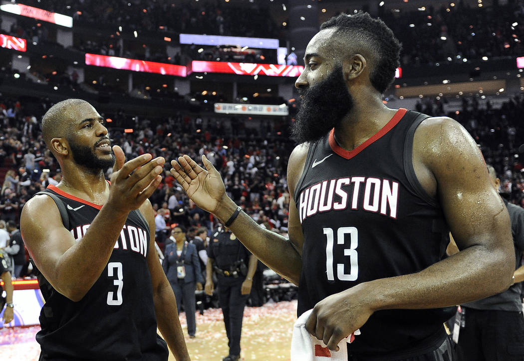 Houston Rockets guard Chris Paul (3) and James Harden celebrate the team's win over the Utah Jazz during Game 5 of an NBA basketball second-round playoff series, Tuesday, May 8, 2018, in Houston. ...