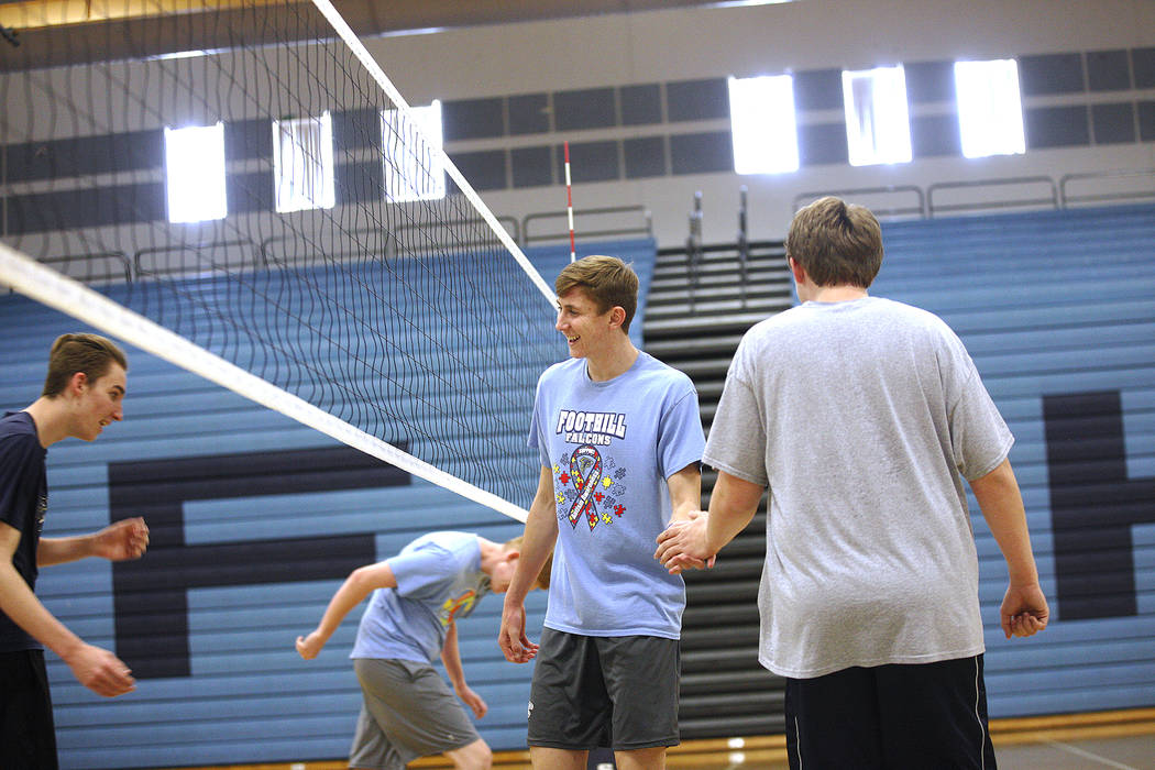 Caleb Stearman, 17, of the Foothill High School mens volleyball team, center, shakes hands with Chandler Higbee, 17, during practice at Foothill High School in Henderson, Monday, May 14, 2018. Ste ...