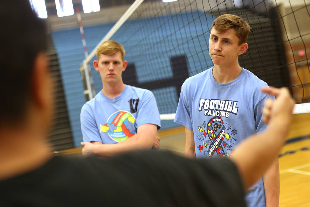 Nathan Cain, left, and Caleb Stearman, 17, of the Foothill High School mens volleyball team, listen to Coach Lewis Miranda during practice at Foothill High School in Henderson, Monday, May 14, 201 ...