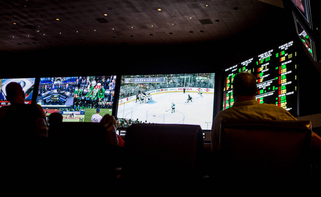 Sports betters watch the Golden Knights play the San Jose Sharks during the second round of the NHL playoffs at the Green Valley Ranch sports book in Henderson on Thursday, April 26, 2018. Patric ...