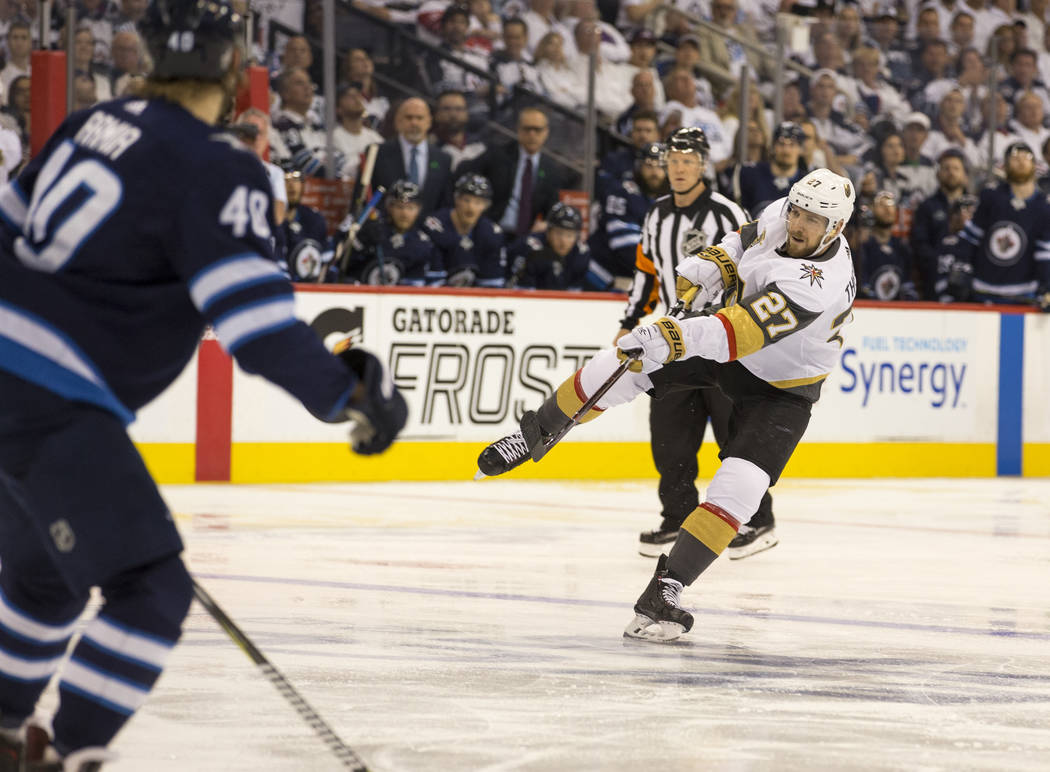 Vegas Golden Knights defenseman Shea Theodore (27) takes a shot on goal against the Winnipeg Jets during the second period in Game 2 of an NHL hockey third round playoff series at the Bell MTS Pla ...