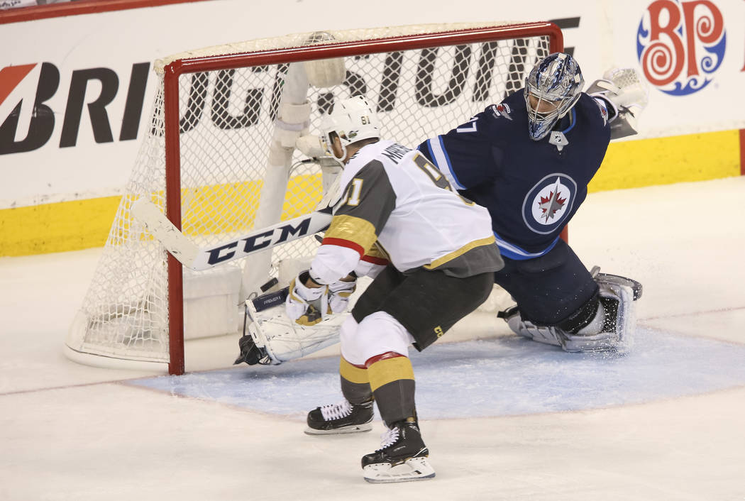 Vegas Golden Knights center Jonathan Marchessault (81) scores against Winnipeg Jets goaltender Connor Hellebuyck (37) during the third period in Game 2 of an NHL hockey third round playoff series ...