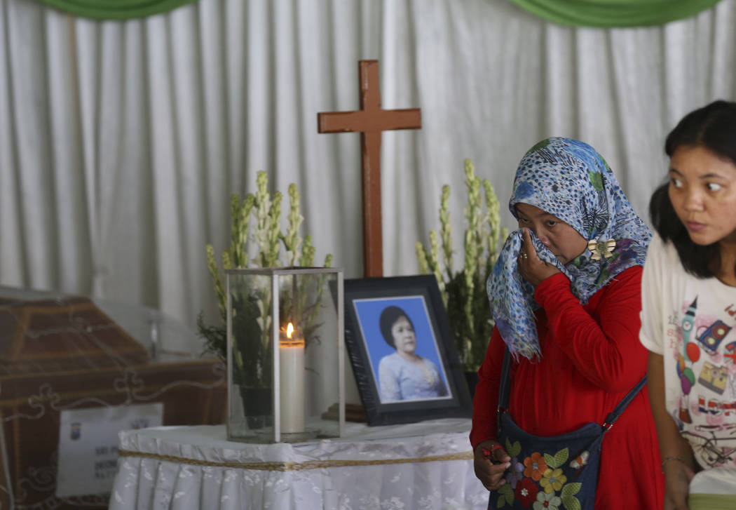 A Muslim woman weeps during the wake for Sri Pudji Astutik, one of the victims of Sunday's church attacks, at a funeral home in Surabaya, East Java, Indonesia, Monday, May 14, 2018. The flurry of ...