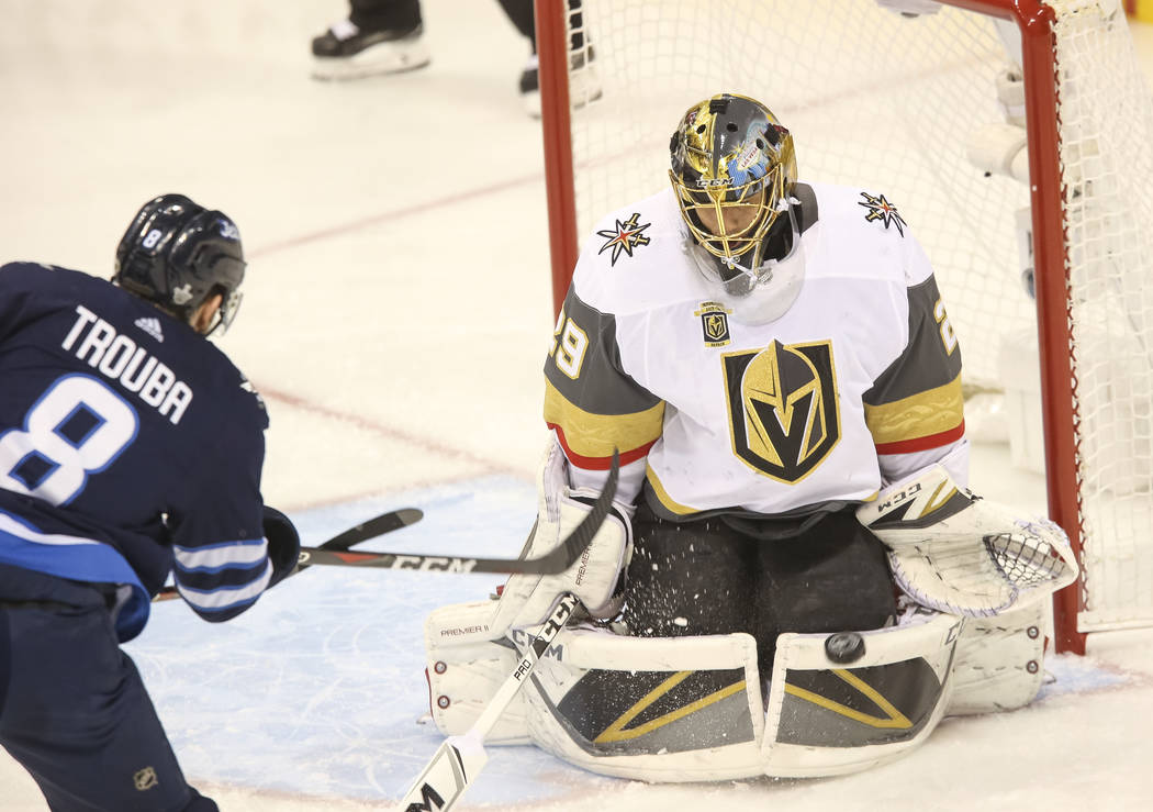 Vegas Golden Knights goaltender Marc-Andre Fleury (29) block a shot from Winnipeg Jets defenseman Jacob Trouba (8) during the first period in Game 1 of an NHL hockey third round playoff series at ...