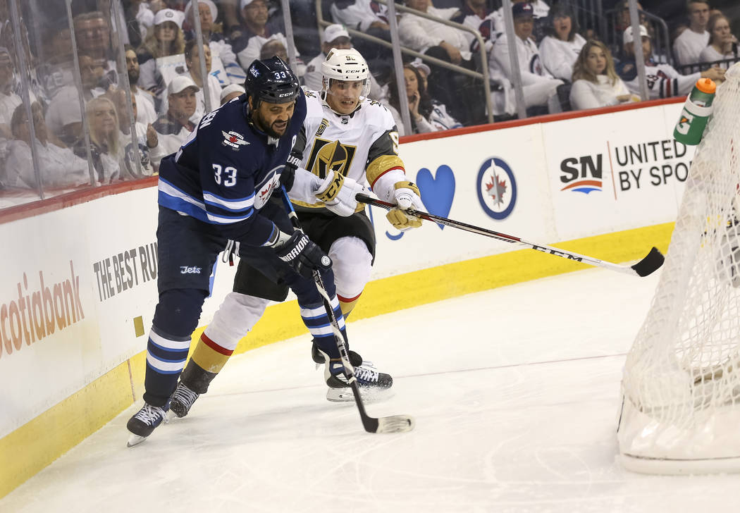 Winnipeg Jets defenseman Dustin Byfuglien (33) keeps the away from Vegas Golden Knights left wing Tomas Nosek (92) during the second period in Game 2 of an NHL hockey third round playoff series at ...