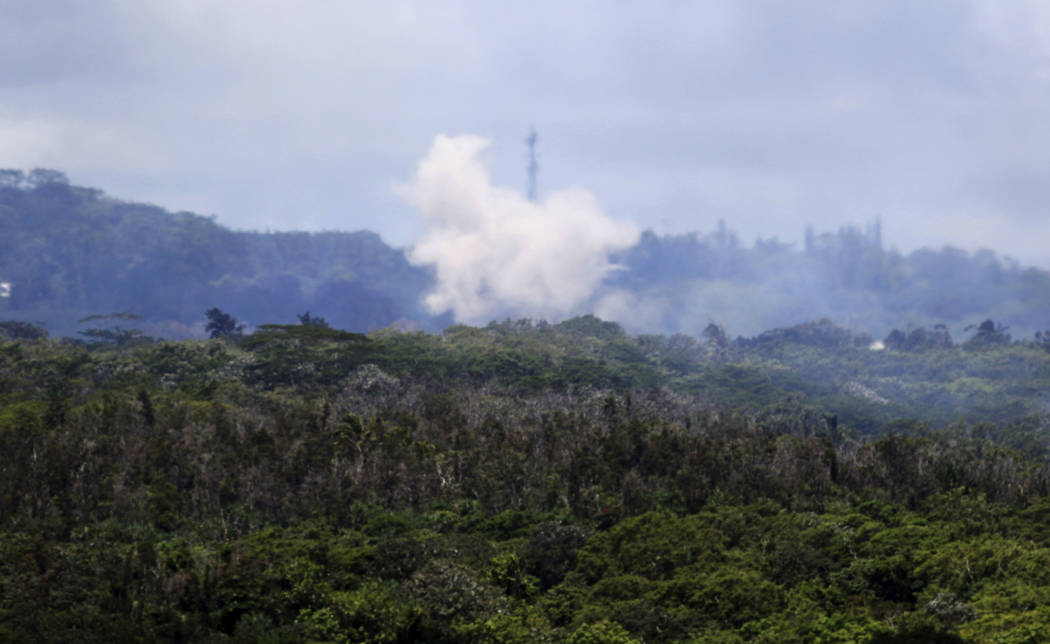 Volcanic gases and ash rise from recent lava fissures near Pahoa, Hawaii on Monday, May 14, 2018. People nixing vacations to Hawaii's Big island has cost the tourism industry millions of dollars a ...