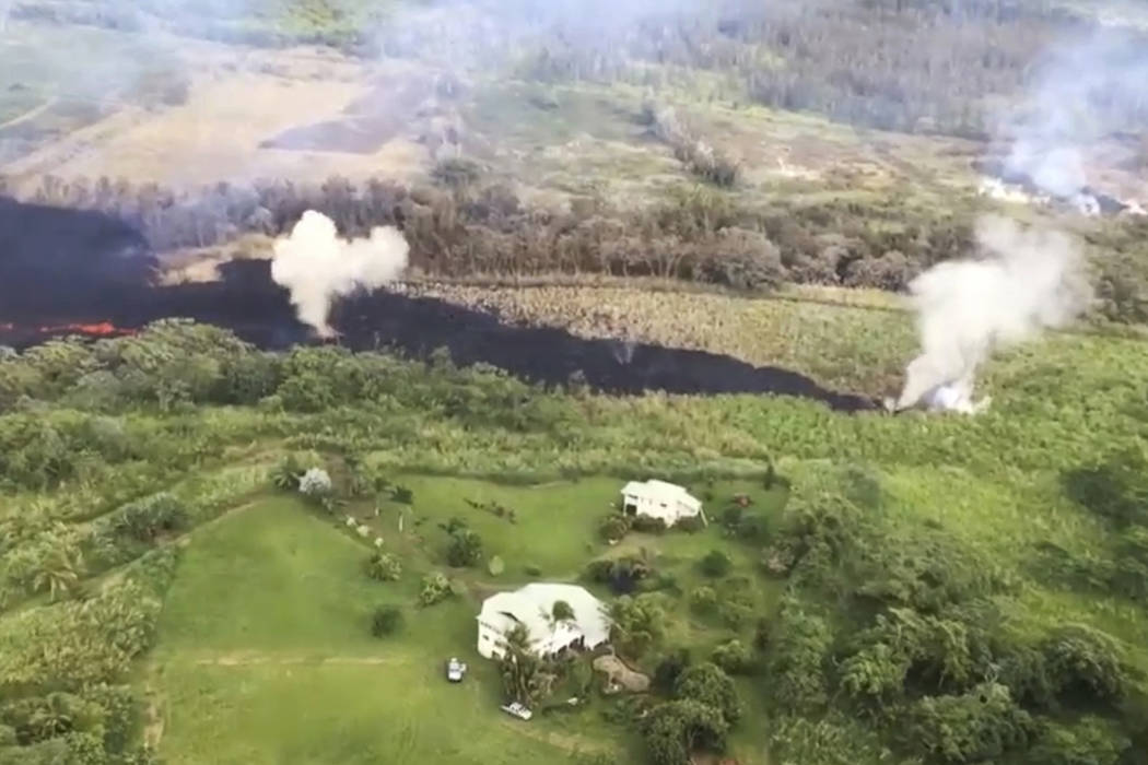 In this May 13, 2018 frame from video released by the U.S. Geological Survey, gases rise from a fissure near Pahoa, Hawaii. The new fissure sent gases and lava exploding into the air, spurring off ...