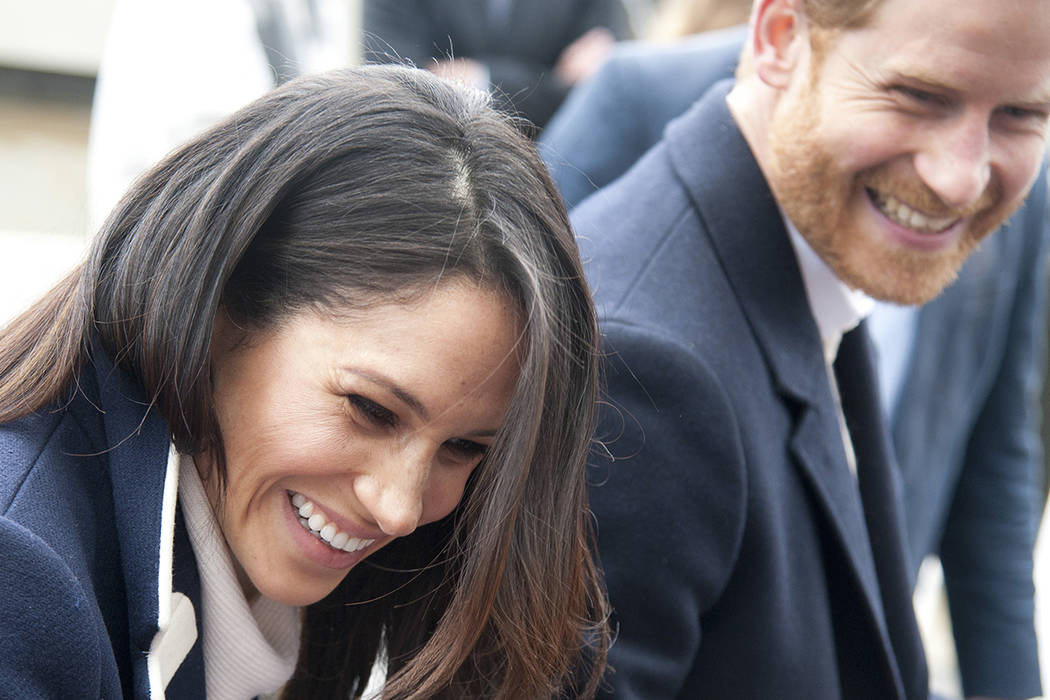 In this file photo dated Thursday March 8, 2018, Britain's Prince Harry and his fiancee Meghan Markle arrive for an event for young women, as part of International Women's Day in Birmingham, centr ...