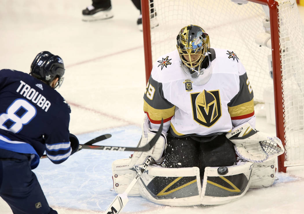 Vegas Golden Knights goaltender Marc-Andre Fleury (29) block a shot from Winnipeg Jets defenseman Jacob Trouba (8) during the first period in Game 2 of an NHL hockey third round playoff series at ...