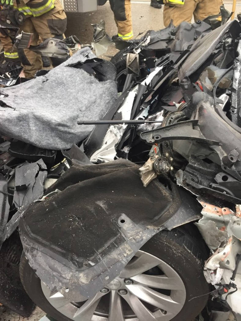 In this Friday, May 11, 2018, photo released by the South Jordan Police Department shows a traffic collision involving a Tesla Model S sedan with a Fire Department mechanic truck stopped at a red ...