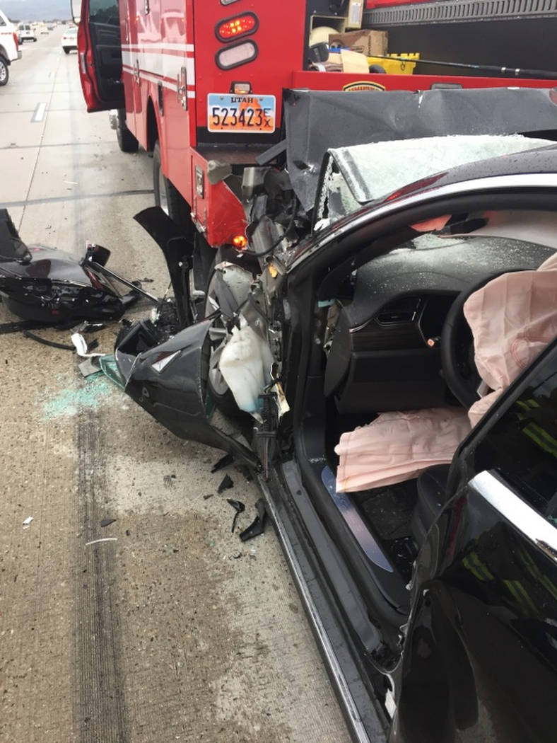 In this Friday, May 11, 2018, photo released by the South Jordan Police Department shows a traffic collision involving a Tesla Model S sedan with a Fire Department mechanic truck stopped at a red ...