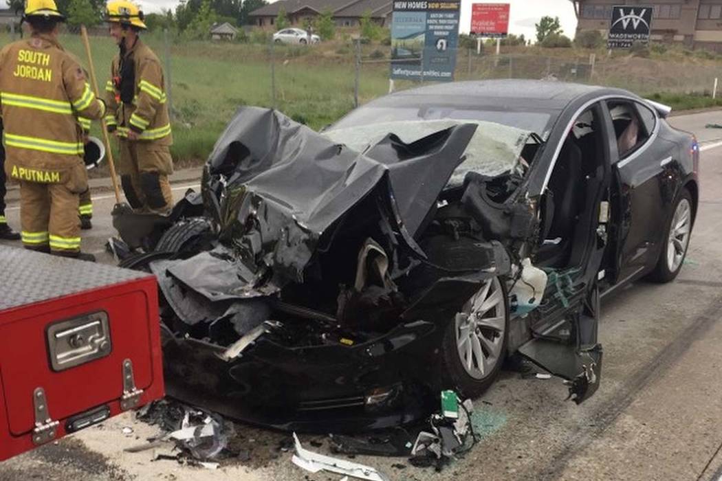 In this Friday, May 11, 2018, photo released by the South Jordan Police Department shows a traffic collision involving a Tesla Model S sedan with a Fire Department mechanic truck stopped at a red ...