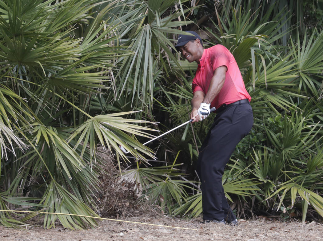 Tiger Woods hits from the rough off the second hole fairway, during the final round of the Players Championship golf tournament, Sunday, May 13, 2018, in Ponte Vedra Beach, Fla. (AP Photo/Lynne Sl ...