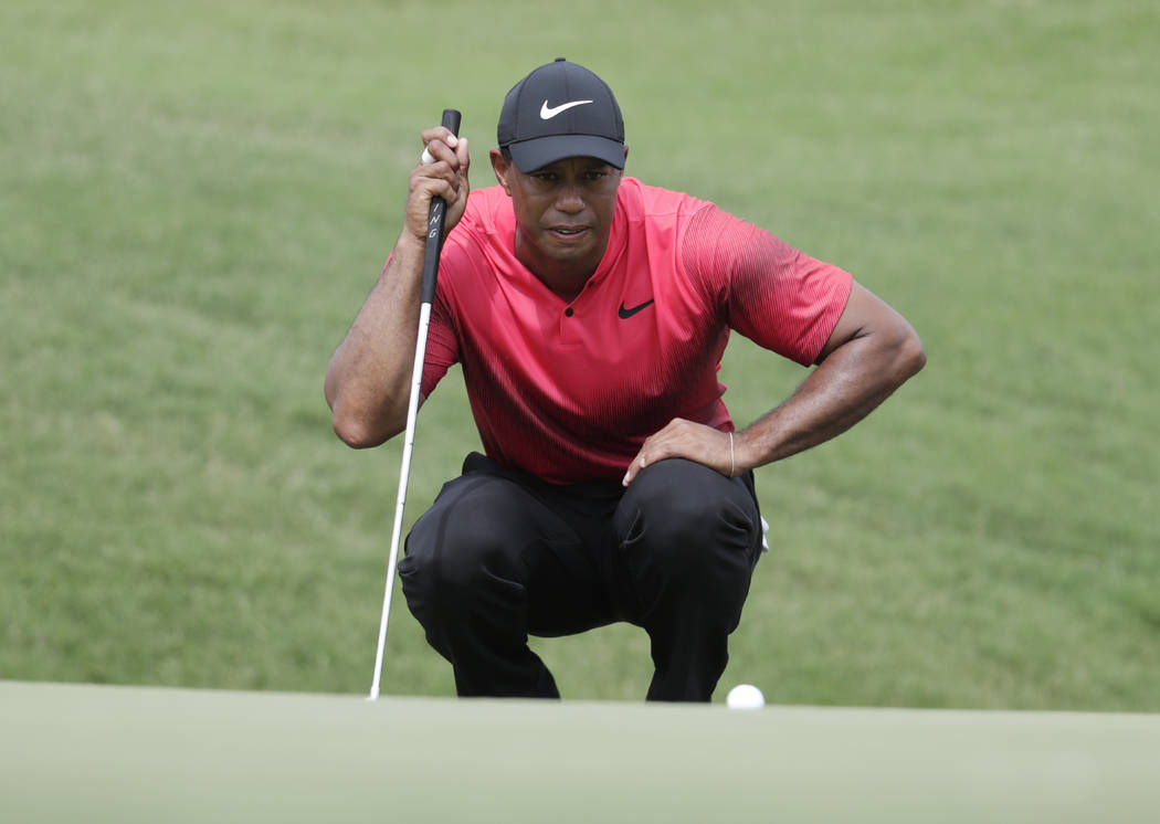 Tiger Woods looks at his shot on the ninth green, during the final round of The Players Championship golf tournament, Sunday, May 13, 2018, in Ponte Vedra Beach, Fla. (AP Photo/Lynne Sladky)