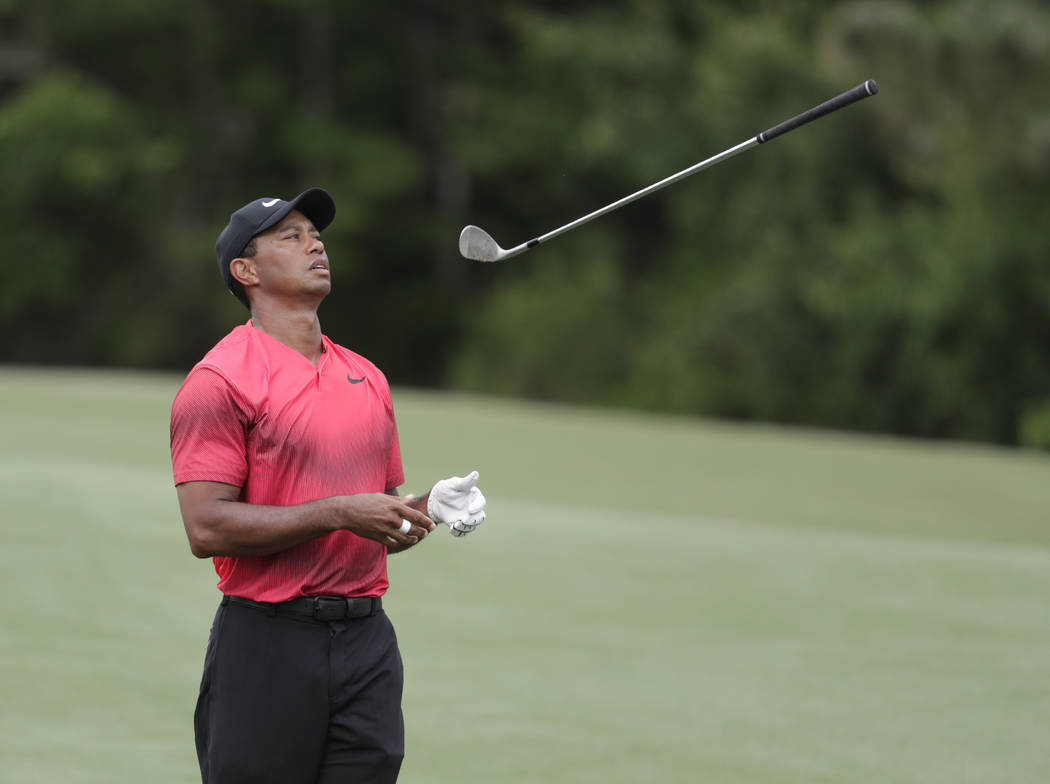 Tiger Woods throws his club in frustration on the 14 fairway, during the final round of The Players Championship golf tournament Sunday, May 13, 2018, in Ponte Vedra Beach, Fla. (AP Photo/)