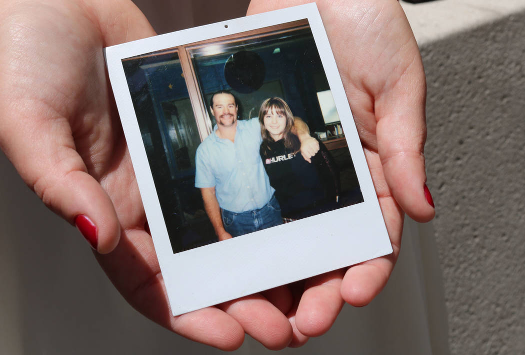 Breanna Boppre holds a photo of herself and her father, Scott Schlingheyde, in Las Vegas, Thursday, May 10, 2018. The photo was taken in a prison visiting room; Boppre doesn't recall how old she w ...