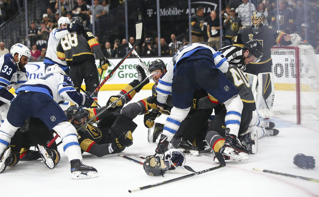 Golden Knights and Winnipeg Jets players get into an altercation during the second period of Game 3 of the NHL Western Conference finals hockey playoff series at T-Mobile Arena in Las Vegas on Wed ...