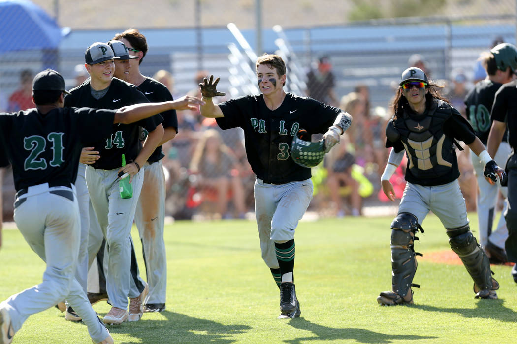 Palo Verde E.J. Arnold (34) celebrates with his teammates after scoring against Centennial in the third inning of their Sunset Region baseball game at Centennial High School Thursday, May 10, 2018 ...