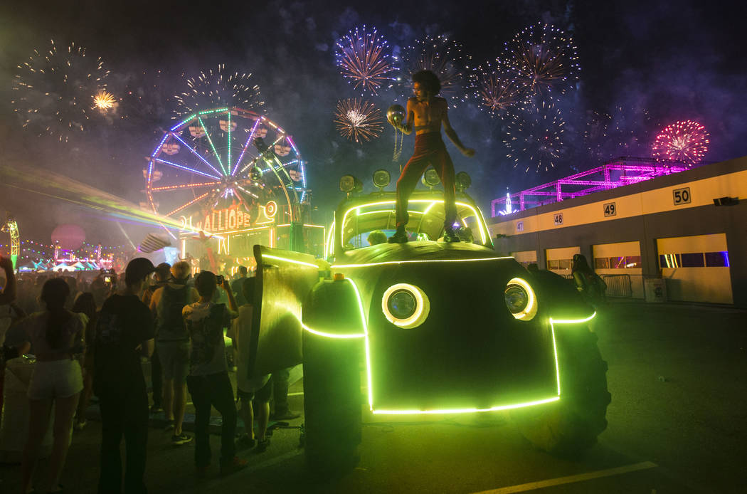 Deven Williams of the Kalliope dances on an art car as fireworks go off during the third day of the Electric Daisy Carnival at the Las Vegas Motor Speedway in Las Vegas during the early hours of M ...