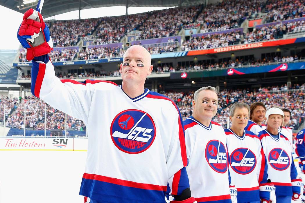 Jim Kyte #6 of the Winnipeg Jets alumni team waves to the crowd during team introductions for the 2016 Tim Hortons NHL Heritage Classic Alumni Game to be played against the Edmonton Oilers alumni ...