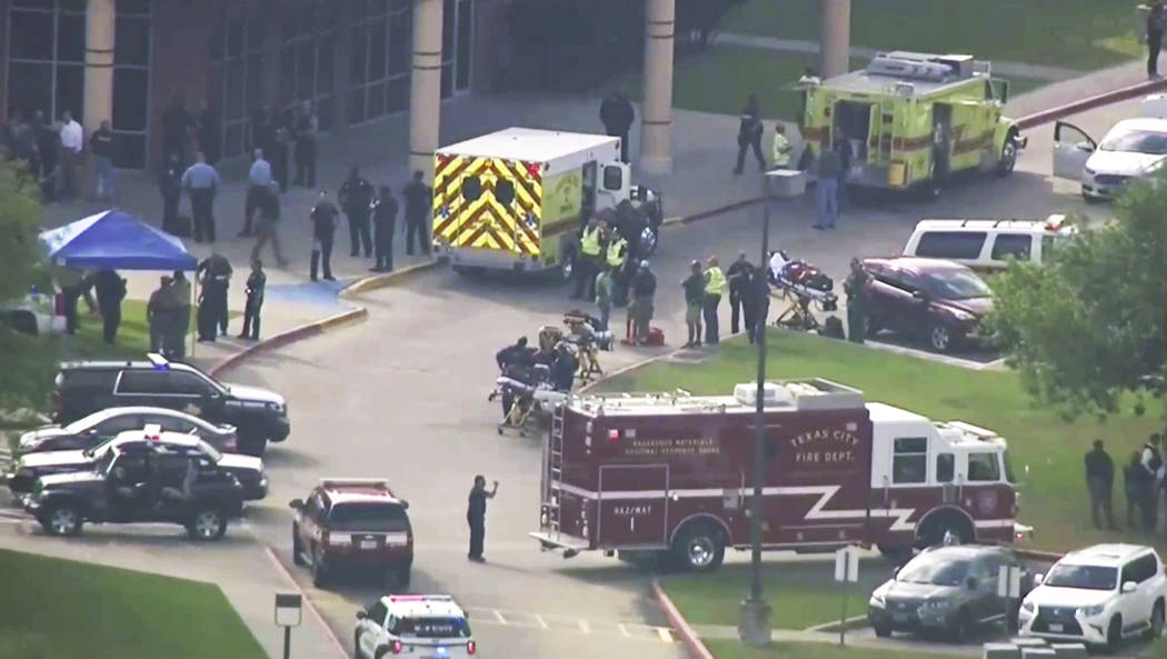In this image taken from video emergency personnel and law enforcement officers respond to a high school near Houston after an active shooter was reported on campus, Friday, May 18, 2018, in Santa ...