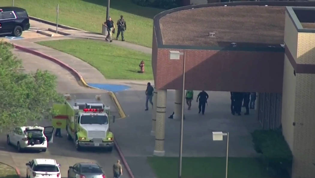 In this image taken from video law enforcement officers respond to a high school near Houston after an active shooter was reported on campus, Friday, May 18, 2018, in Santa Fe, Texas. The Santa Fe ...