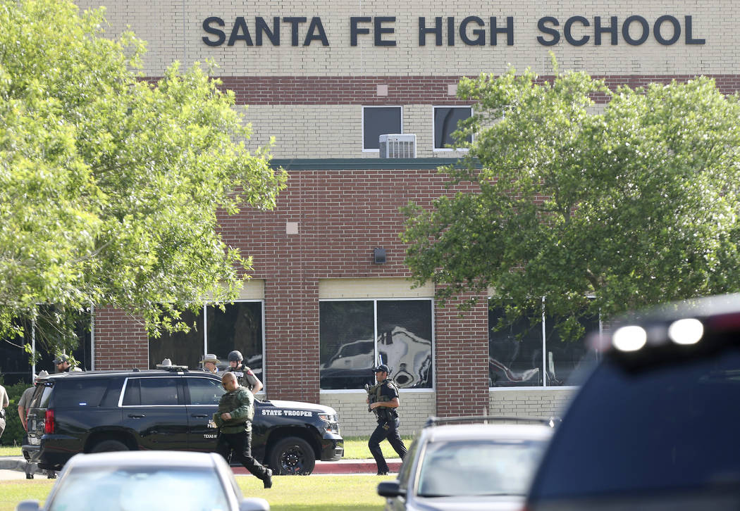 Law enforcement officers respond to Santa Fe High School after an active shooter was reported on campus, Friday, May 18, 2018, in Santa Fe, Texas. ( Steve Gonzales/Houston Chronicle via AP)