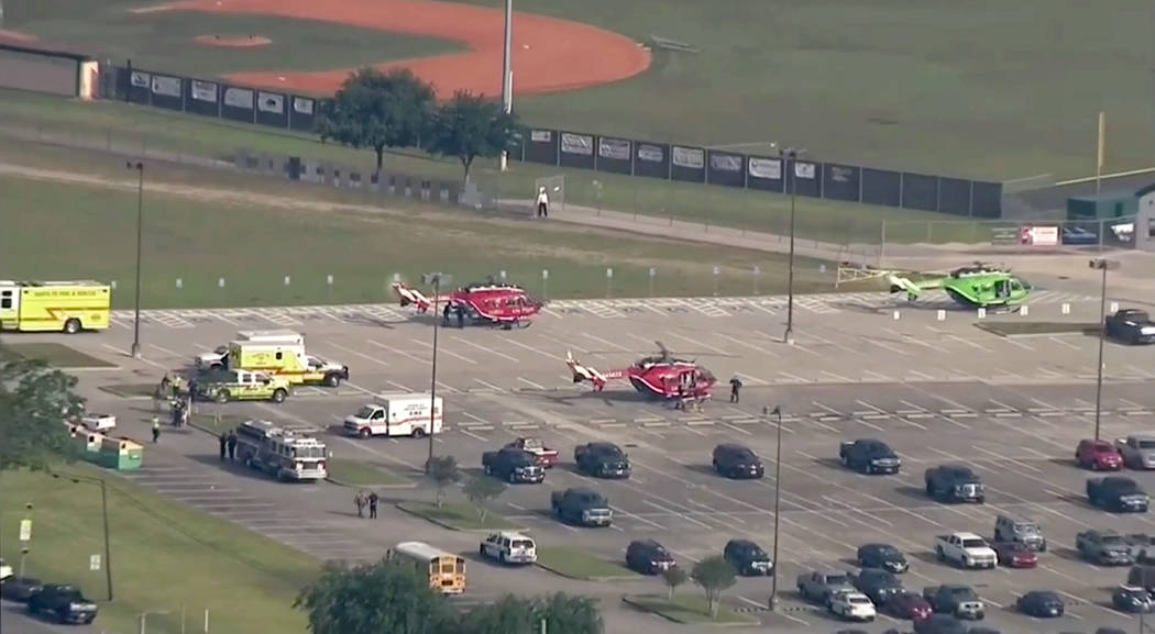 In this image taken from video helicopters sit in the parking lot of Santa Fe High School as law enforcement officers respond to the school near Houston after an active shooter was reported on cam ...