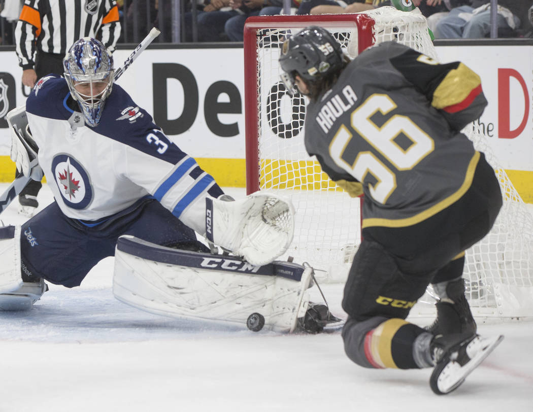 Golden Knights left wing Erik Haula (56) shoots on Jets goaltender Connor Hellebuyck (37) in the first period during game four of Las Vegas' NHL Western Conference Finals matchup with Winnipeg on ...