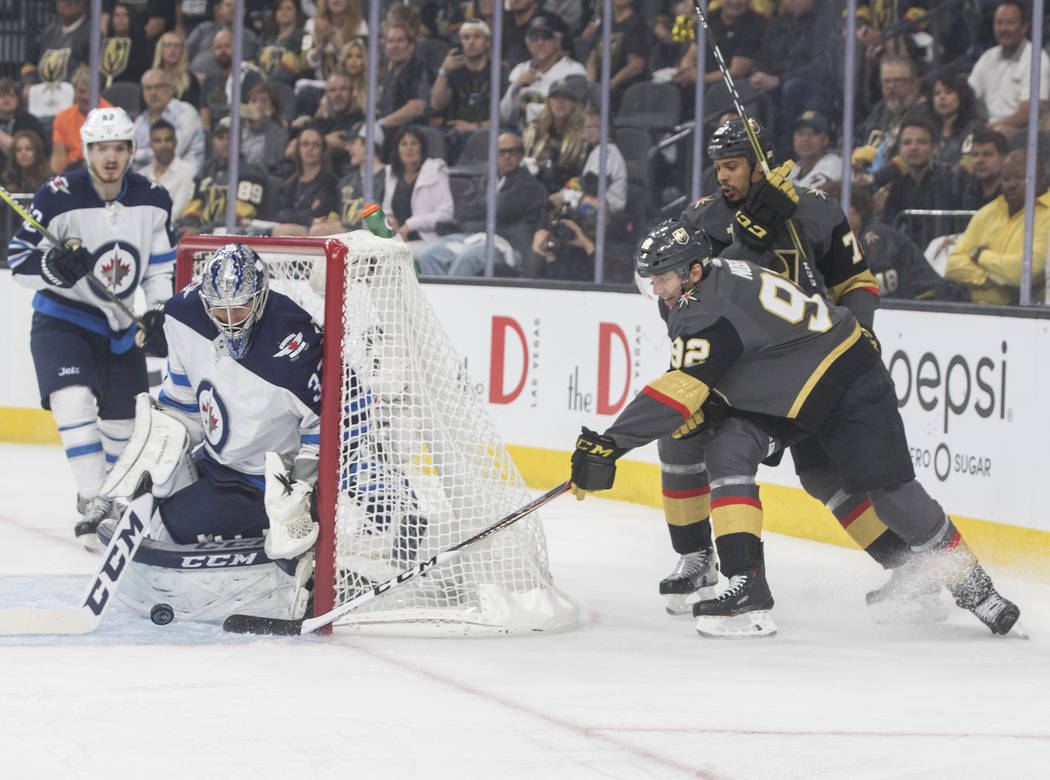 Golden Knights center Tomas Nosek (92) shoots on Jets goaltender Connor Hellebuyck (37) in the first period during game four of Las Vegas' NHL Western Conference Finals matchup with Winnipeg on Fr ...