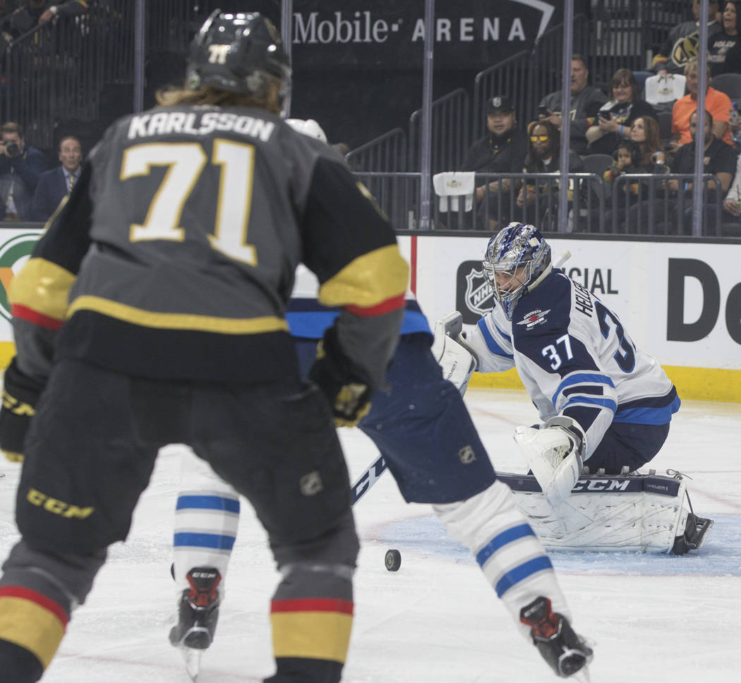 Jets goaltender Connor Hellebuyck (37) makes a save in the first period during game four of Winnipeg's NHL Western Conference Finals matchup with the Golden Knights on Friday, May 18, 2018, at T- ...