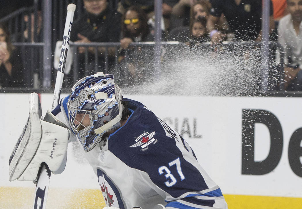 Jets goaltender Connor Hellebuyck (37) makes a save in the first period during game four of Winnipeg's NHL Western Conference Finals matchup with the Golden Knights on Friday, May 18, 2018, at T- ...