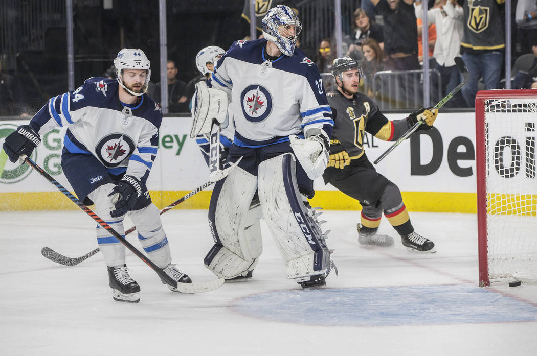 Golden Knights right wing Reilly Smith (19) scores a third period goal against Jets goaltender Connor Hellebuyck (37) during game four of Las Vegas' NHL Western Conference Finals matchup with Winn ...