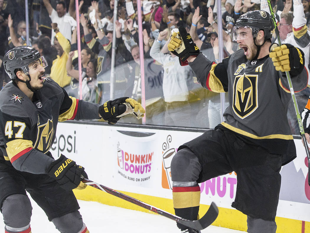Golden Knights right wing Reilly Smith (19) celebrates with Luca Sbisa (47) after scoring a third period goal during game four of Las Vegas' NHL Western Conference Finals matchup with Winnipeg on ...