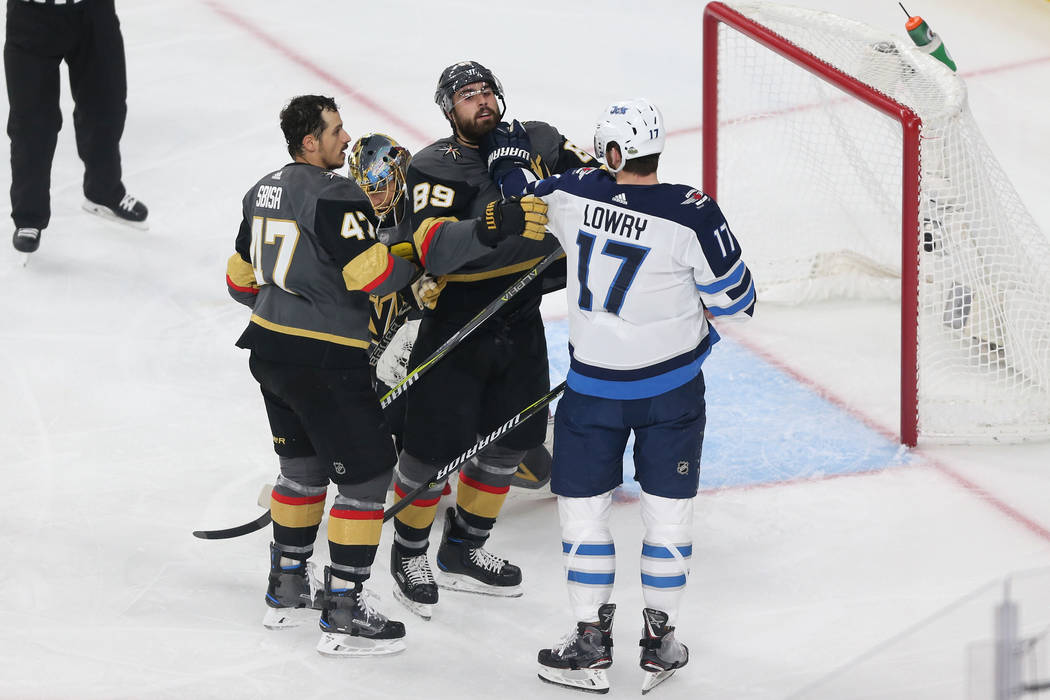 Vegas Golden Knights right wing Alex Tuch (89) and Winnipeg Jets center Adam Lowry (17) get into a scuffle during the first period in Game 4 of the Western Conference Final at T-Mobile Arena in La ...