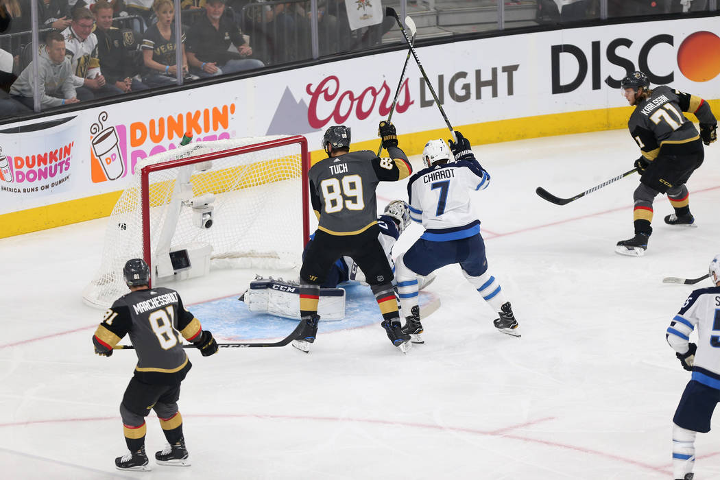 A shot by Vegas Golden Knights center William Karlsson (71) goes in for a score against Winnipeg Jets goaltender Connor Hellebuyck (37) during the first period in Game 4 of the Western Conference ...