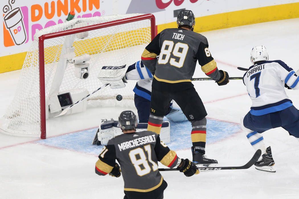 A shot by Vegas Golden Knights center William Karlsson (71) goes in for a score against Winnipeg Jets goaltender Connor Hellebuyck (37) during the first period in Game 4 of the Western Conference ...