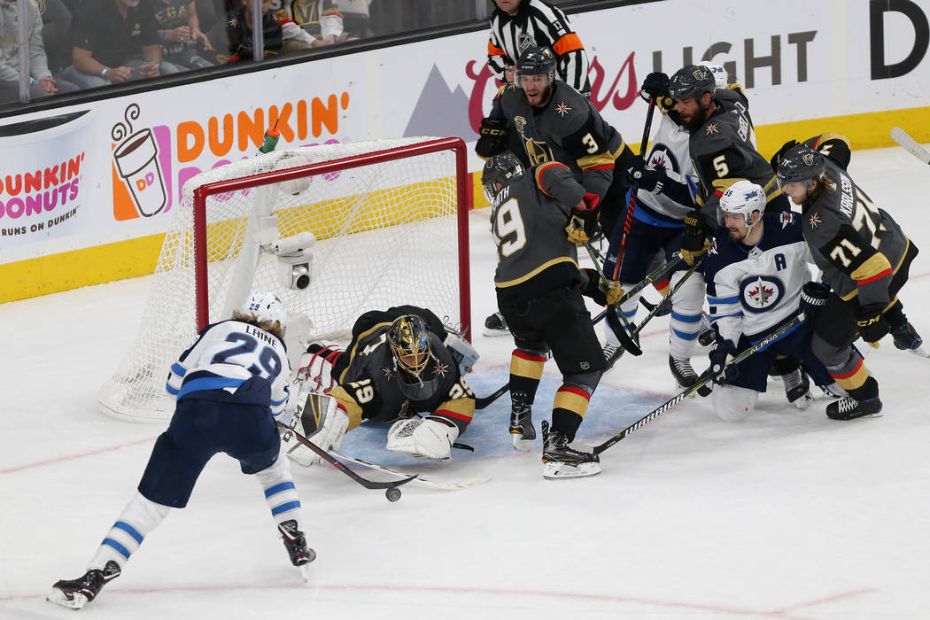 Vegas Golden Knights goaltender Marc-Andre Fleury (29) dives for a stop against Winnipeg Jets right wing Patrik Laine (29) during the second period in Game 4 of the Western Conference Final at T-M ...