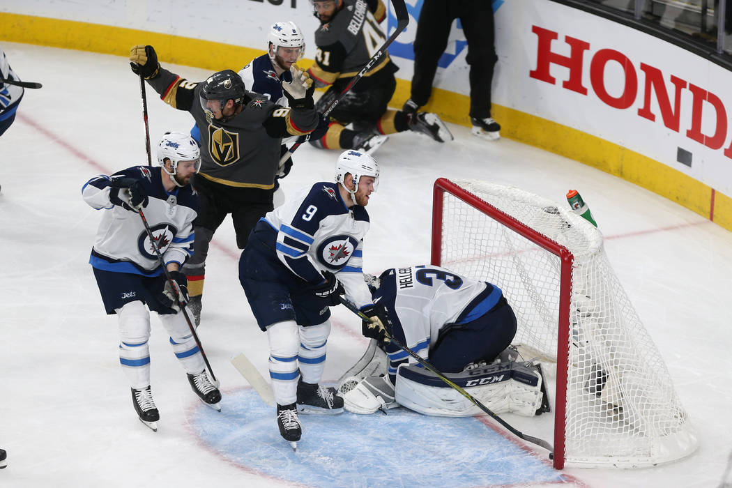 Vegas Golden Knights left wing Tomas Nosek (92) reacts after a shot for a score against Winnipeg Jets goaltender Connor Hellebuyck (37) during the second period in Game 4 of the Western Conference ...
