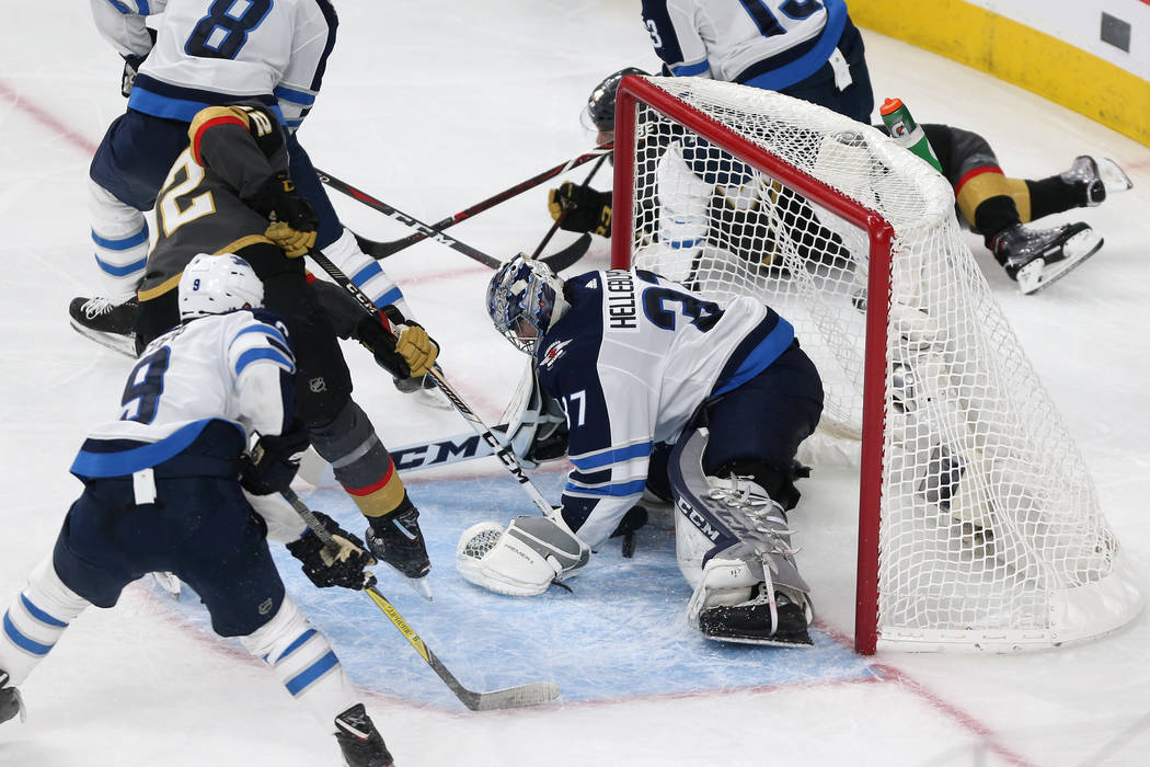 Vegas Golden Knights left wing Tomas Nosek (92) shoots for a score against Winnipeg Jets goaltender Connor Hellebuyck (37) during the second period in Game 4 of the Western Conference Final at T-M ...