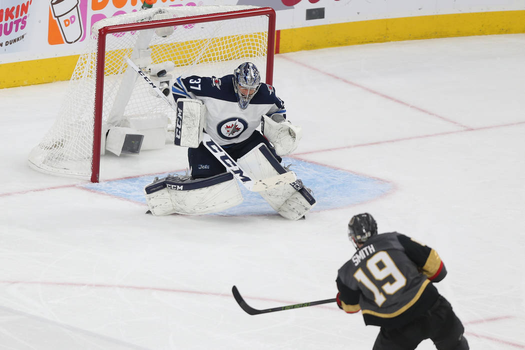 Vegas Golden Knights right wing Reilly Smith (19) scores the game winning goal against Winnipeg Jets goaltender Connor Hellebuyck (37) during the third period in Game 4 of the Western Conference F ...