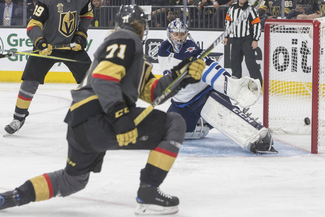 Golden Knights center William Karlsson (71) scores a first period goal against Jets goaltender Connor Hellebuyck (37) during game four of Las Vegas' NHL Western Conference Finals matchup with Winn ...