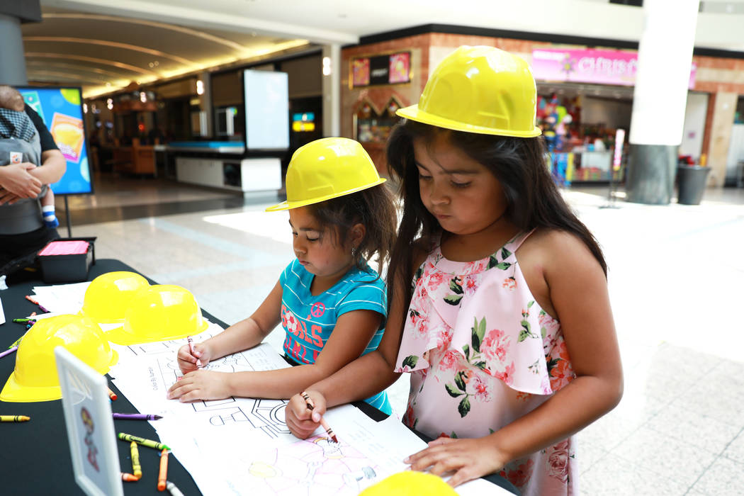 Nicole Montesdeoca, 6, left, and her sister Kimberly, 8, color during the Reading Rangers Summer Reading Program at Boulevard Mall in Las Vegas on Saturday, May 19, 2018. Students were given the o ...