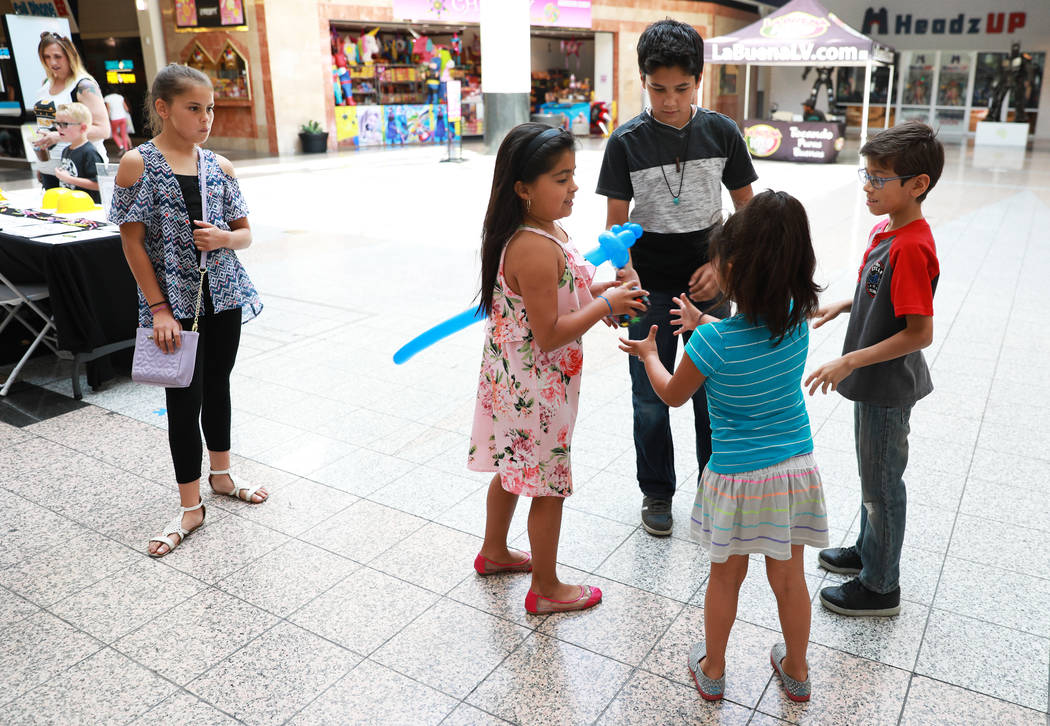 Students play a game of hot potato during the Reading Rangers Summer Reading Program at Boulevard Mall in Las Vegas on Saturday, May 19, 2018. Students were given the opportunity to meet Reading R ...
