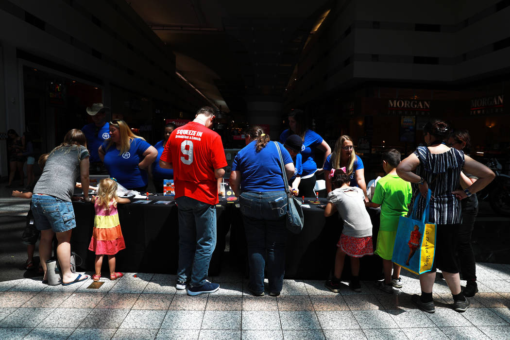 Families attend the Reading Rangers Summer Reading Program at Boulevard Mall in Las Vegas on Saturday, May 19, 2018. Students were given the opportunity to meet Reading Rangers superhero character ...