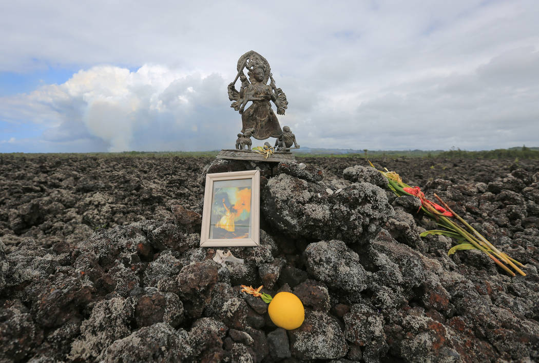 Offerings to Pele the Fire Goddess are left along Kapoho Road near Leilani Estates, Hawaii, where an ash plume from the ongoing Kilauea eruptions is visible, on Saturday, May 19, 2018. Brett LeBla ...