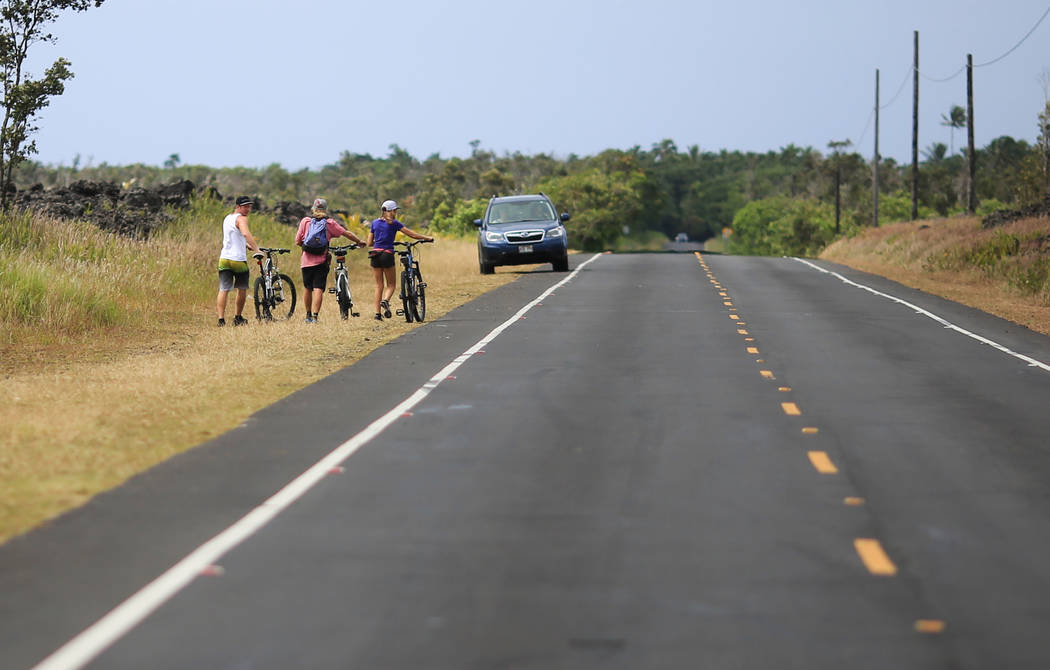 Bikers walk along Kapoho Road near Leilani Estates, Hawaii, where the Kilauea eruptions continues on Saturday, May 19, 2018. Brett LeBlanc Las Vegas Review-Journal
