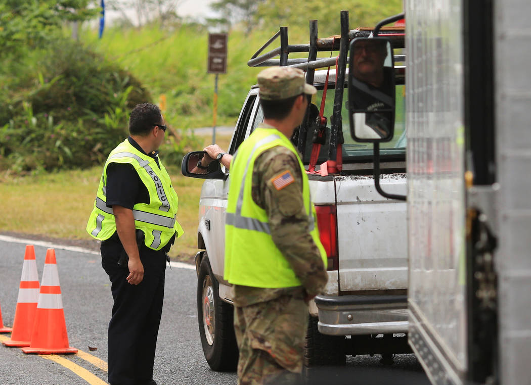 Police and National Guardsmen run a checkpoint into the area affected by the Kilauea eruptions in Leilani Estates, Hawaii, on Saturday, May 19, 2018. Brett LeBlanc Las Vegas Review-Journal