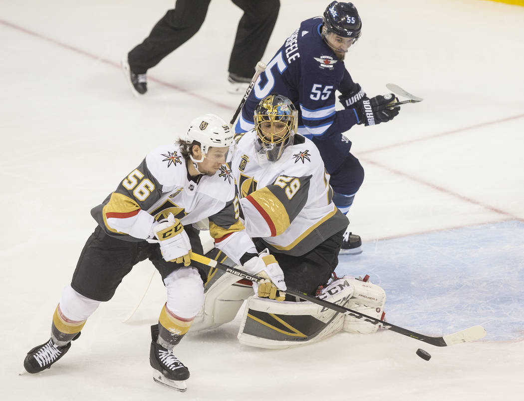 Golden Knights goaltender Marc-Andre Fleury (29) makes a save with the help of left wing Erik Haula (56) in the first period during game five of the NHL Western Conference Finals on Sunday, May ...