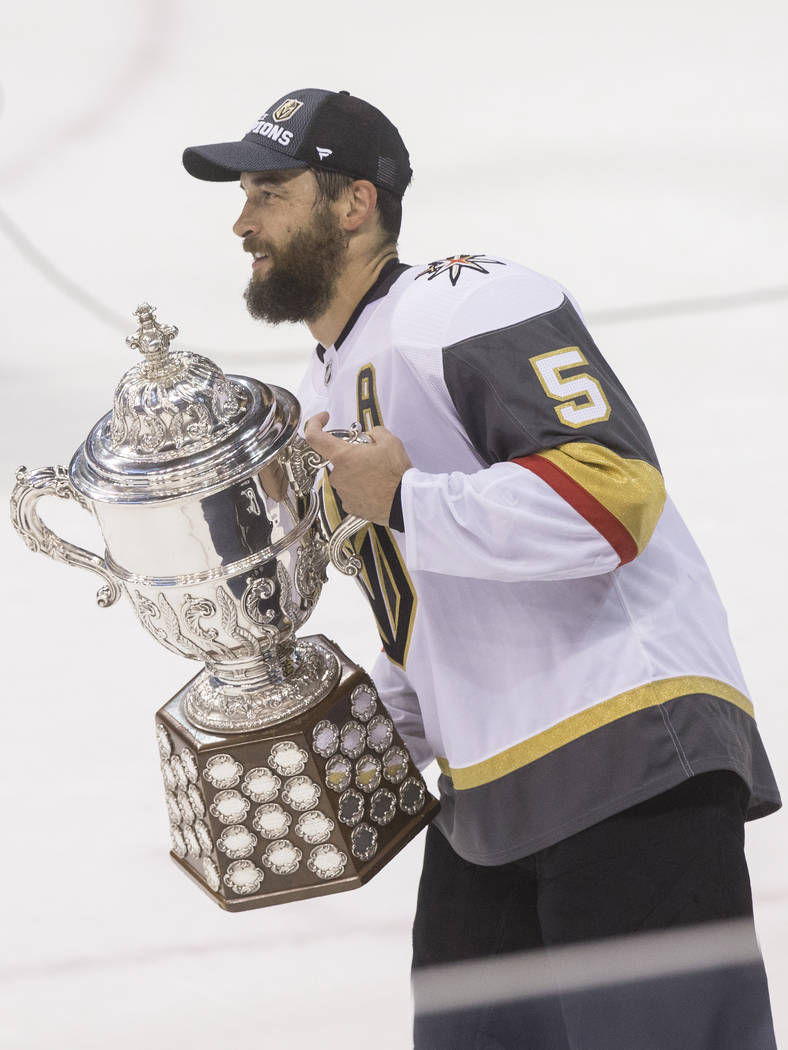 Golden Knights defenseman Deryk Engelland (5) holds the Clarence Campbell Bowl trophy after Las Vegas beat the Winnipeg Jets 2-1 to advance to the Stanley Cup Finals on Sunday, May 20, 2018, at Be ...